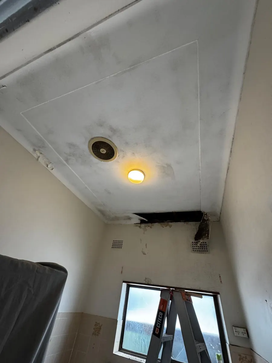 Before: ceiling with a large hole and water damage