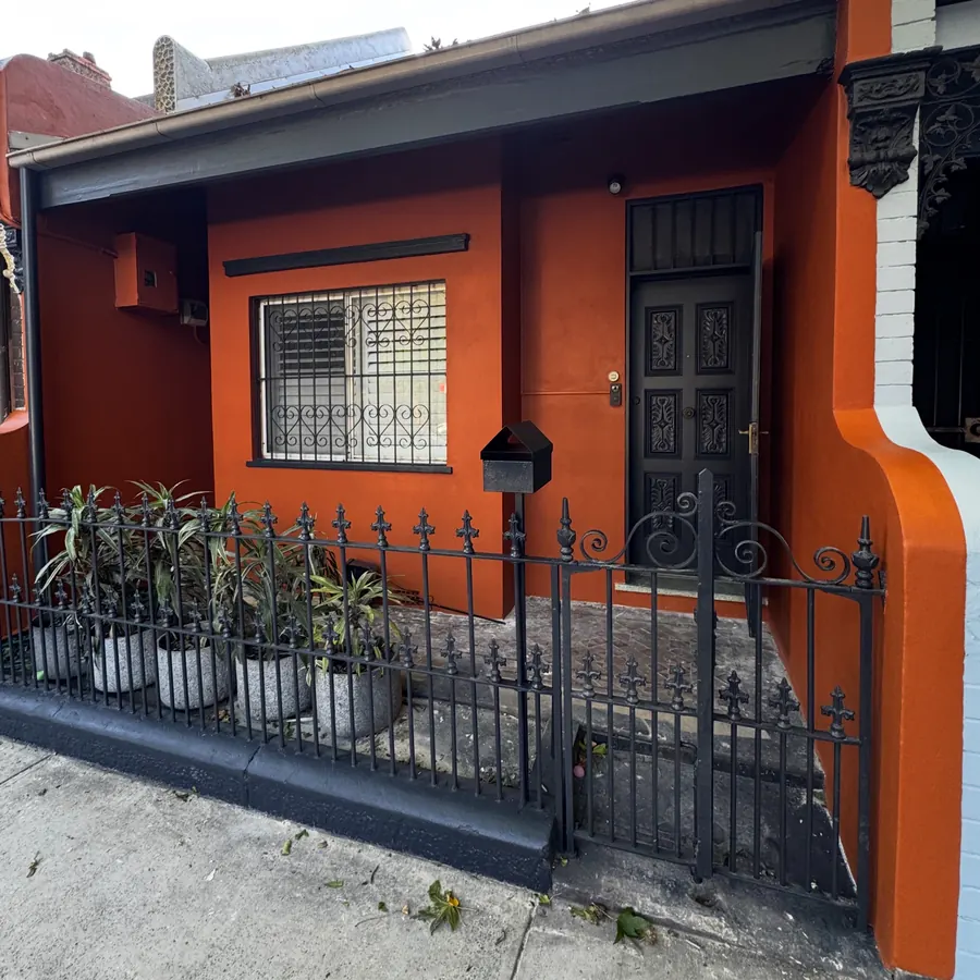 Terrace facade renewed in orange with black trims