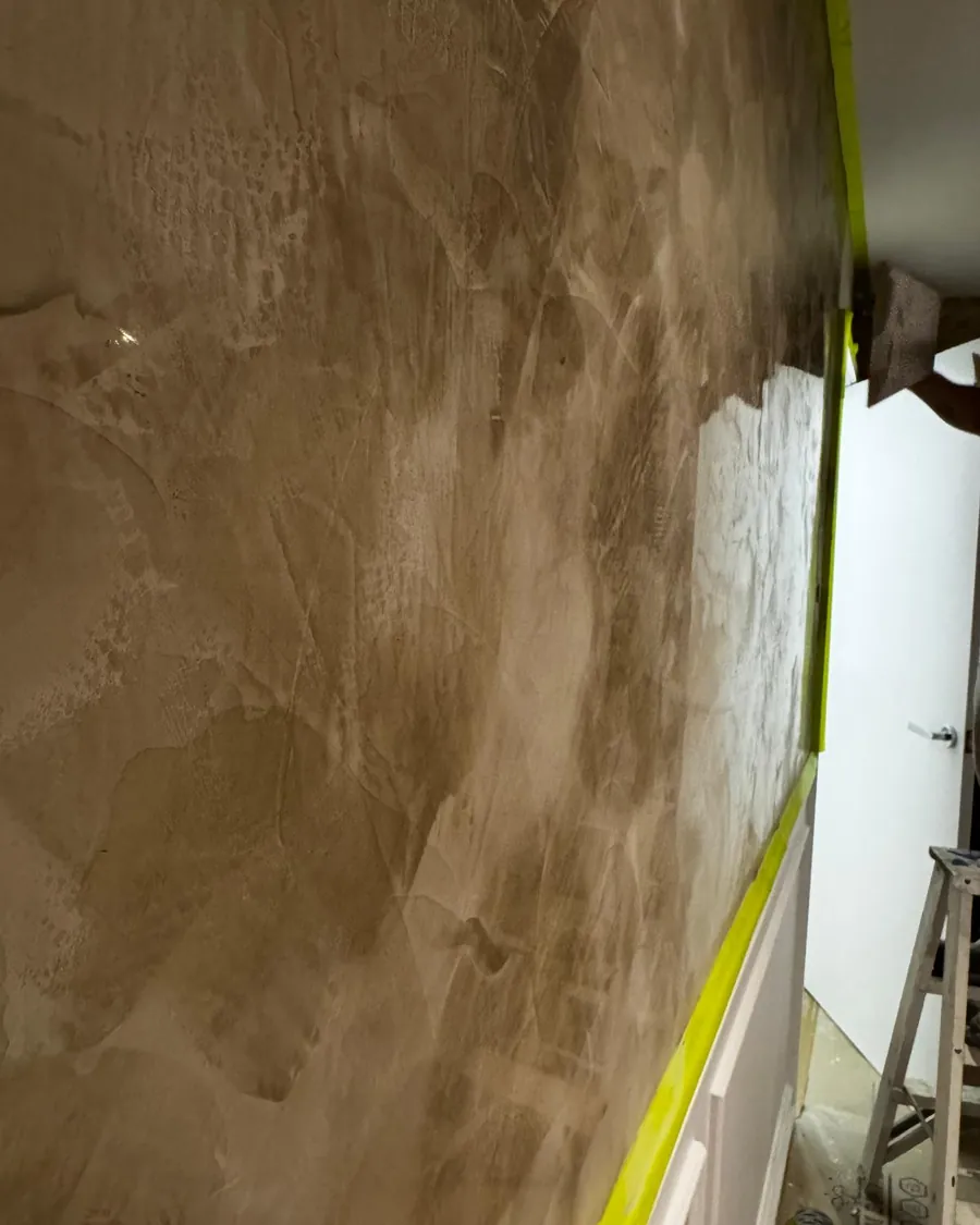 Golden Venetian plaster being applied to a feature wall