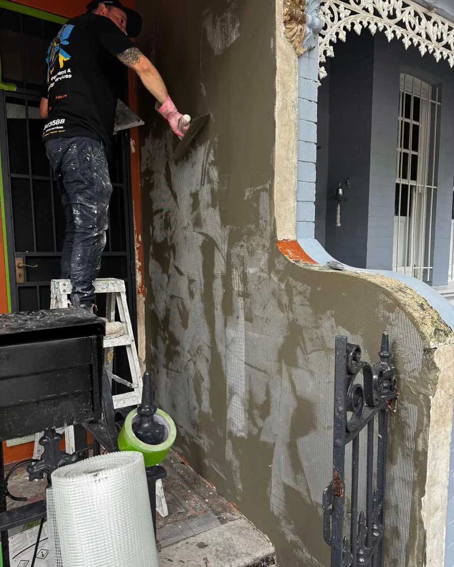 Tradesman rendering the facade of a terrace house